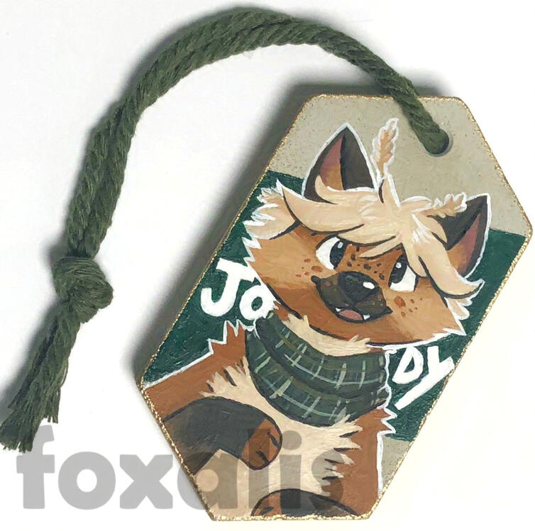 A photo of a geometic cast ornament with a critter painted on it.